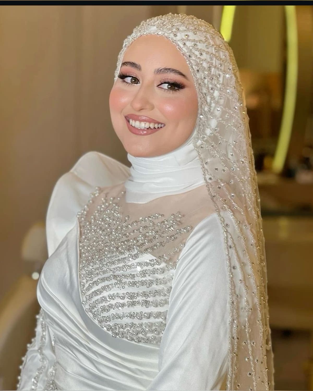 Hijabi bride in Sharjah with specialist hijab-compatible bridal makeup, precise eye work defined brows and flawless skin finish by Elani Artistry